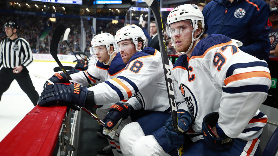 VANCOUVER, BC - DECEMBER 23: Connor McDavid #97 of the Edmonton Oilers looks on from the bench during their NHL game against the Vancouver Canucks at Rogers Arena December 23, 2019 in Vancouver, British Columbia, Canada.  (Photo by Jeff Vinnick/NHLI via Getty Images)"n