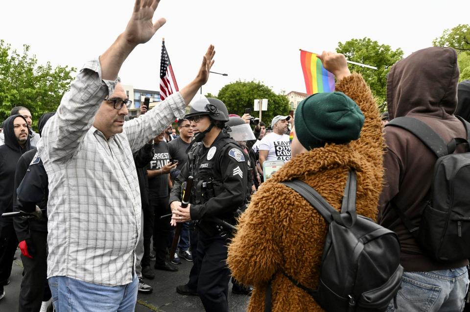 Conservative groups and LGBTQ+ rights supporters protest as police try to maintain order outside the Glendale Unified School District offices in Glendale, California.