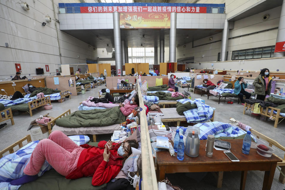 In this Feb. 21, 2020, photo, patients rest at a temporary hospital at Tazihu Gymnasium in Wuhan in central China's Hubei province. Top Chinese officials secretly determined they were likely facing a pandemic from a novel coronavirus in mid-January, ordering preparations even as they downplayed it in public. Internal documents obtained by the AP show that because warnings were muffled inside China, it took a confirmed case in Thailand to jolt Beijing into recognizing the possible pandemic before them. (Chinatopix via AP)