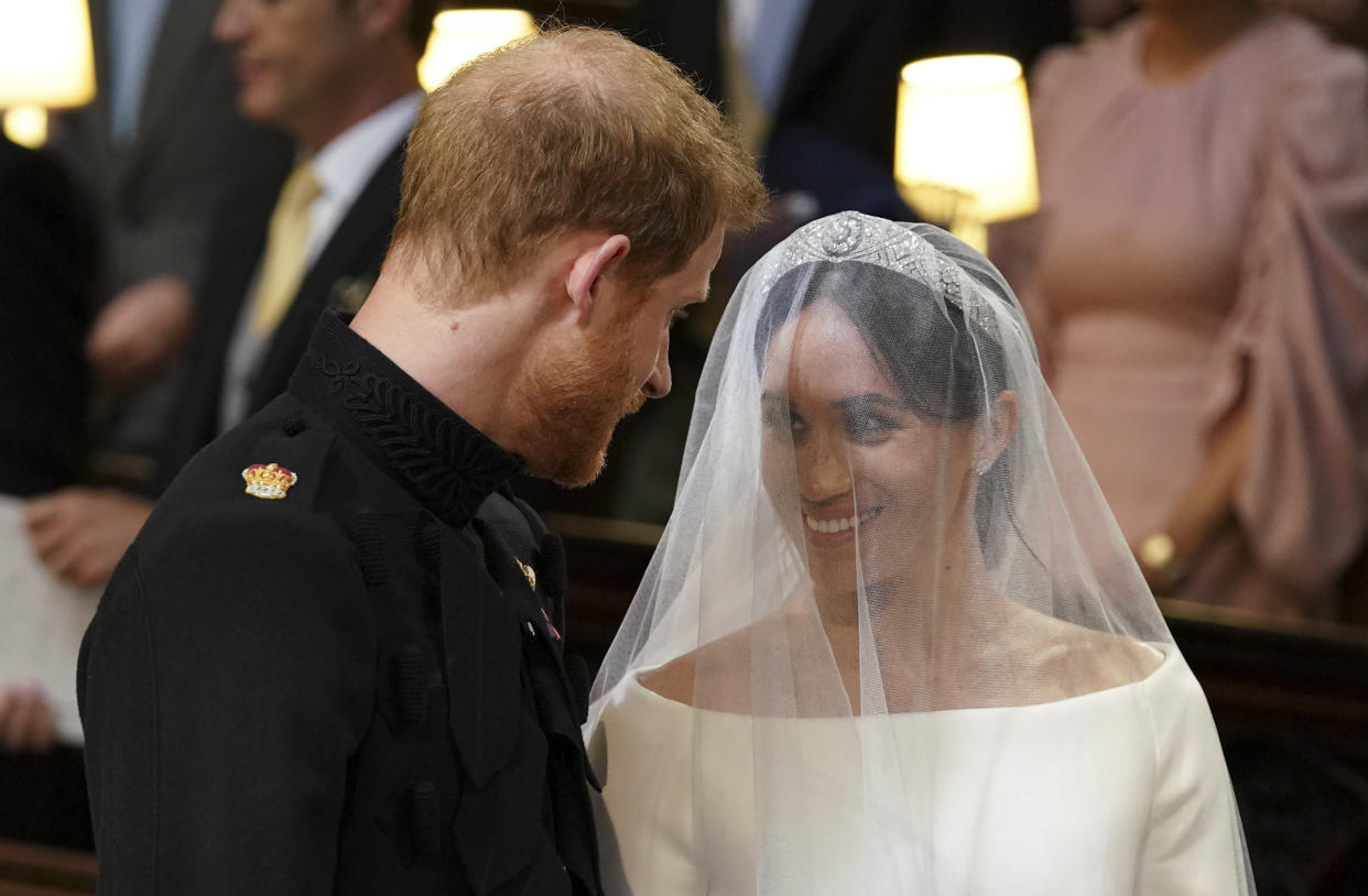 TOPSHOT - Britain's Prince Harry, Duke of Sussex (L) and US actress Meghan Markle (R) stand together at the altar in St George's Chapel, Windsor Castle, in Windsor, on May 19, 2018 during their wedding ceremony. (Photo by Dominic Lipinski / POOL / AFP)        (Photo credit should read DOMINIC LIPINSKI/AFP via Getty Images)