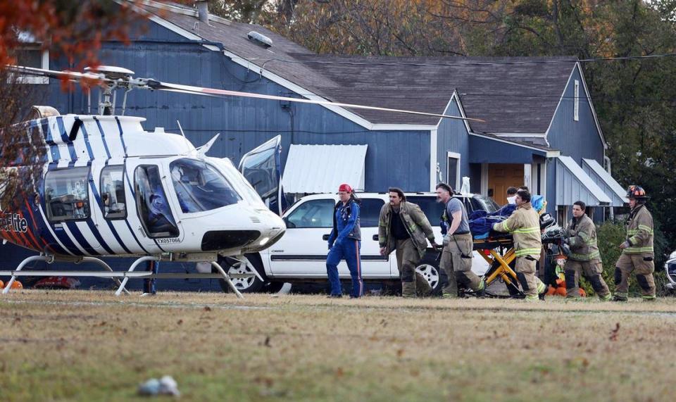 Fort Worth firefighters and emergency personnel carry an injured person to a CareFlite helicopter for transport on Thursday, December 1, 2022. A house exploded on the 5600 block of Watters Place, injuring one person.