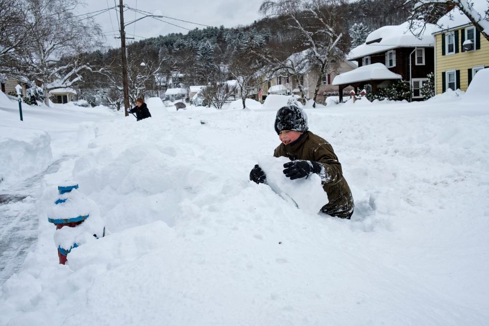 John Gilfillan, 7, of Binghamton, N.Y., makes the best of an a heavy snowfall in front of his home on Thursday, Dec. 17, 2020. Binghamton Airport reported 39.1 inches of snow and another spot in Binghamton reported 41.0 inches, according to the National Weather Service.