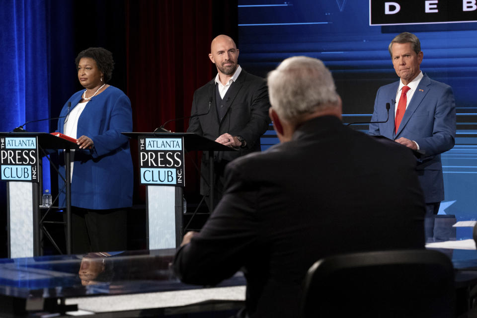 Democratic challenger Stacey Abrams, from left, Libertarian challenger Shane Hazel and Republican Georgia Gov. Brian Kemp participate in a gubernatorial debate during the Atlanta Press Club Loudermilk-Young Debate Series in Atlanta on Monday, Oct. 17, 2022. (AP Photo/Ben Gray)