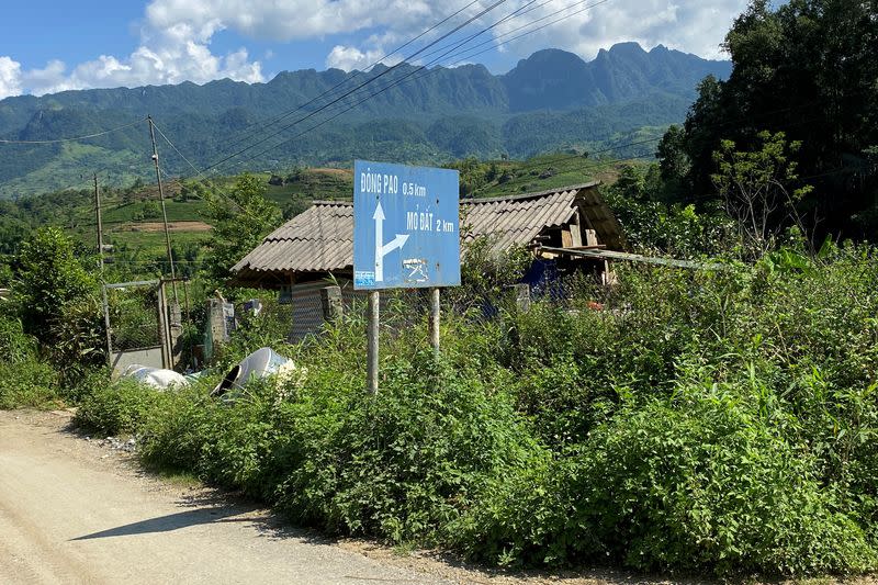 An undated photo shows a signboard showing the way to Dong Pao mine