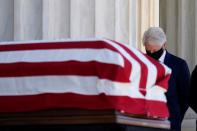 Former President Bill Clinton arrives to pay respects as Justice Ruth Bader Ginsburg lies in repose under the Portico at the top of the front steps of the U.S. Supreme Court building, in Washington