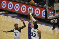 Phoenix Suns' Deandre Ayton (22) shoots over Minnesota Timberwolves's Karl-Anthony Towns (32) in the first half of an NBA basketball game Sunday, Feb. 28, 2021, in Minneapolis. (AP Photo/Stacy Bengs)