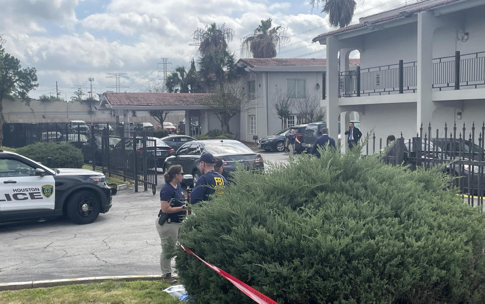 The FBI works on the scene of a shooting, Thursday, March 23, 2023 in north Houston. Officials say one person has been fatally shot during a hostage rescue in Houston. In a statement, the FBI's Houston office said agents had been part of a multiday law enforcement operation to rescue a group of hostages. (Ralph Green/Houston Chronicle via AP)