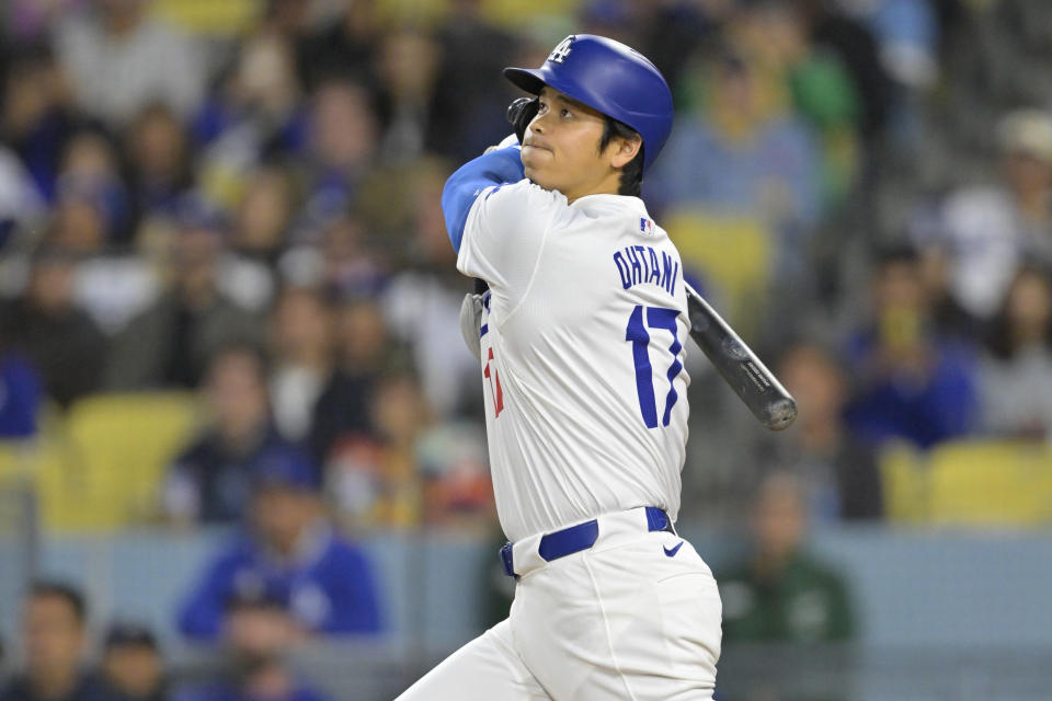 LOS ANGELES, CALIFORNIA - APRIL 12: Shohei Ohtani #17 of the Los Angeles Dodgers watches the flight of the ball on a solo home run in the first inning against the San Diego Padres at Dodger Stadium on April 12, 2024 in Los Angeles, California. (Photo by Jayne Kamin-Oncea/Getty Images)
