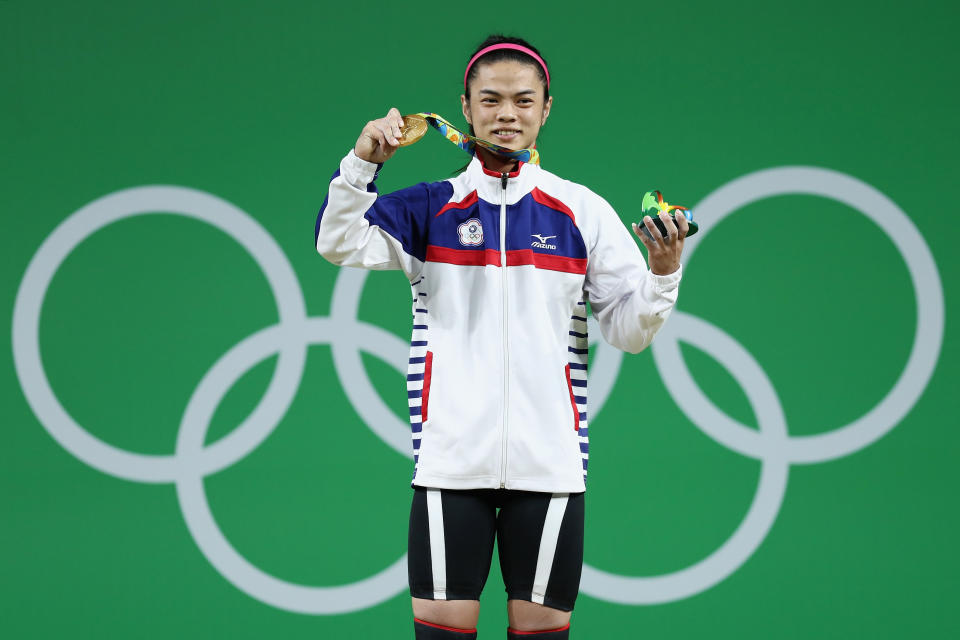 RIO DE JANEIRO, BRAZIL - AUGUST 07:  Gold medalist, Shu-Ching Hsu of Chinese Taipei celebrates on the podium after the Women's 53kg Group A weightlifting contest on Day 2 of the Rio 2016 Olympic Games at Riocentro - Pavilion 2 on August 7, 2016 in Rio de Janeiro, Brazil.  (Photo by Lars Baron/Getty Images)