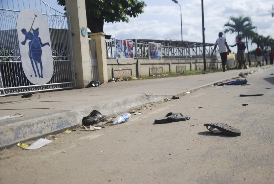 A view of flip fops and sandals on the street, following a stampede in Port Harcourt, Nigeria, Saturday, May 28, 2022. Police say a stampede at a church charity event in southern Nigeria has left at least 31 people dead and seven injured. One witness said the dead included a pregnant woman and “many children.” Police said the stampede took place at an annual “Shop for Free” program organized by the Kings Assembly Pentecostal church in Rivers state. Such events are common in Nigeria, (AP Photo)