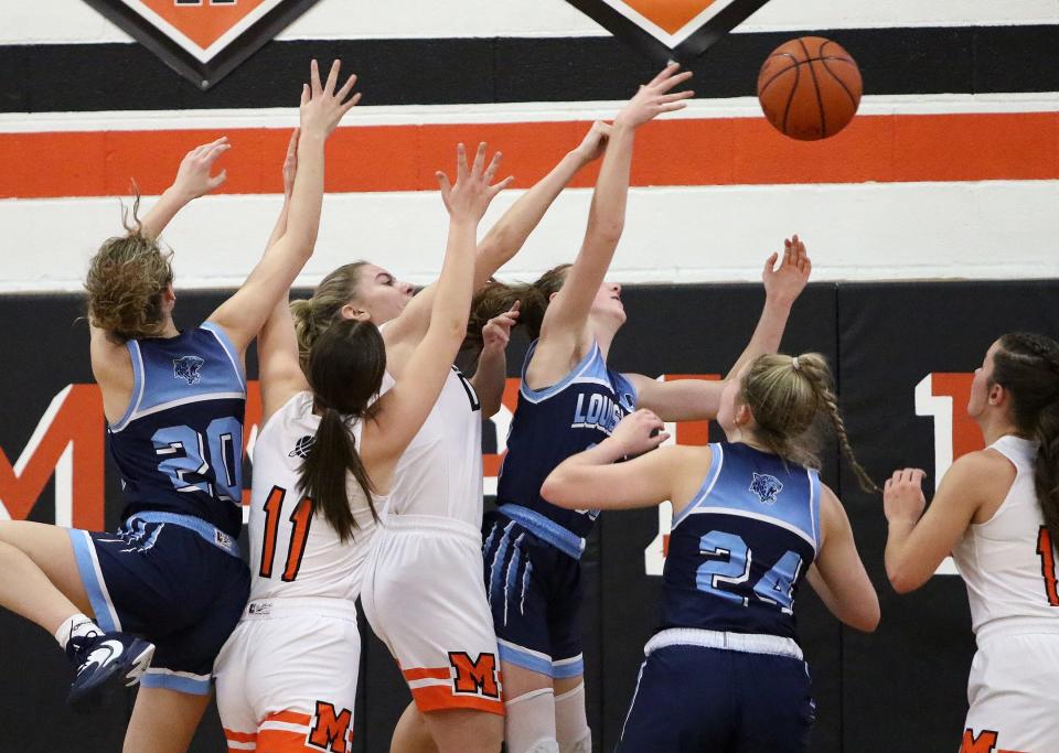 Marlington and Louisville players battle for a rebound during action Saturday afternoon at Marlington High School, January 28, 2023.