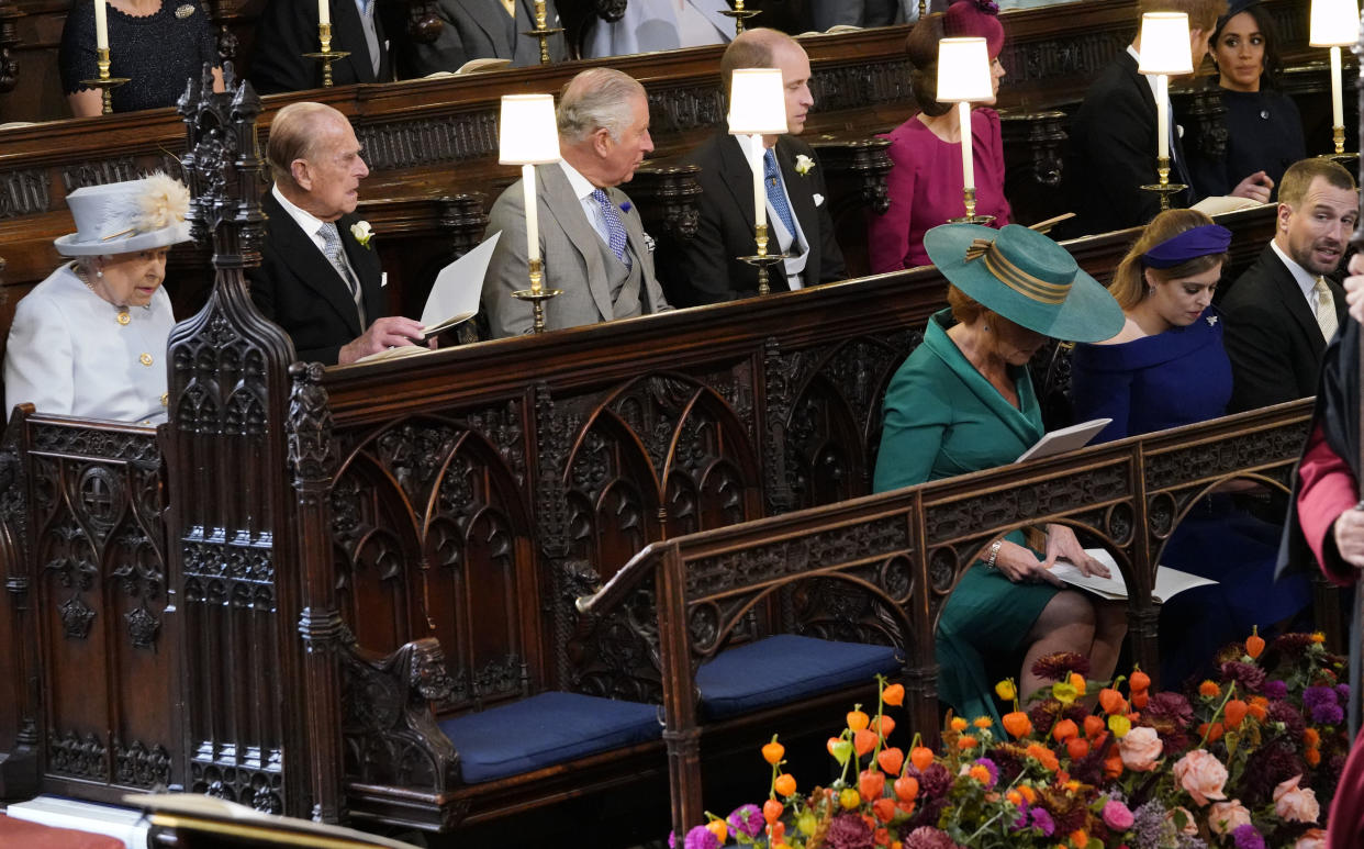 Queen Elizabeth II, the Duke of Edinburgh, Prince of Wales, the Duke and Duchess of Cambridge, the Duke and Duchess of Sussex, sit behind Sarah, Duchess of York, Princess Beatrice and Peter Phillips, at the wedding of Princess Eugenie to Jack Brooksbank at St George's Chapel in Windsor Castle.