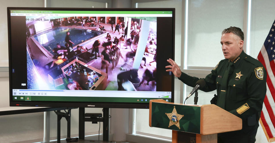 During a press conference in Sanford, Fla., Monday, April 29, 2024, Seminole County Sheriff Dennis Lemma shows a surveillance video taken early Sunday of patrons fleeing the Cabana Live nightclub in Sanford, during shots fired by gunmen. Multiple patrons in the club, including NFL Houston Texans wide receiver Tank Dell, were wounded by the gunfire. (Joe Burbank/Orlando Sentinel via AP)