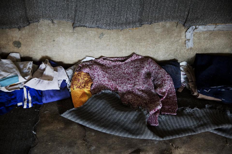 Children's clothes lie on a sofa in an empty house in the abandoned fishing village of Houtouwan on the island of Shengshan July 26, 2015. (REUTERS/Damir Sagolj)