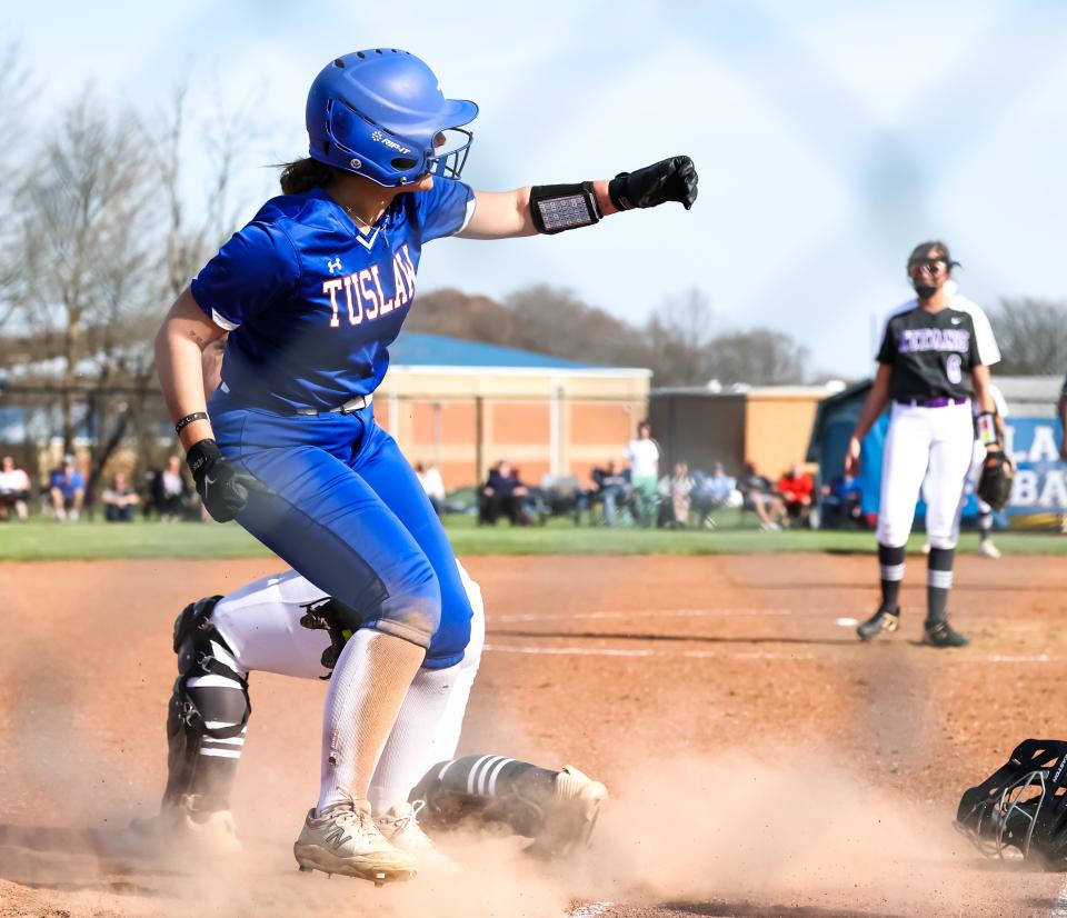 Tuslaw's Kaitlyn Mazzocca celebrates scoring her run in the first inning.
