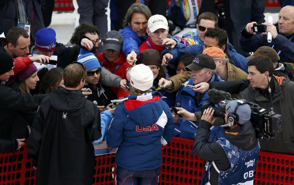 Shiffrin of the U.S. is surrounded by reporters after competing in the first run of the women's alpine skiing slalom event during the 2014 Sochi Winter Olympics at the Rosa Khutor Alpine Center