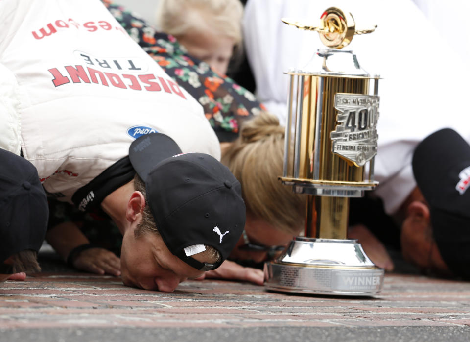 NASCAR Cup Series driver Brad Keselowski (2) kisses the yard of bricks on the start/finish line after winning the NASCAR Brickyard 400 auto race at Indianapolis Motor Speedway in Indianapolis Monday, Sept. 10, 2018. (AP Photo/Rob Baker)