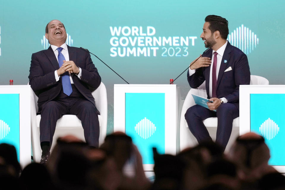 Egyptian President Abdel Fattah el-Sissi, left, reacts during his speech at the World Government Summit opening day in Dubai, United Arab Emirates, Monday, Feb 13, 2023. El-Sissi offered effusive praise Monday for the United Arab Emirates, seeking to repair a rift between Cairo and the Gulf Arab states that have supplied billions of dollars in aid to his nation. (AP Photo/Kamran Jebreili)