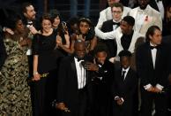 US director Barry Jenkins (C) speaks after "Moonlight" won the Best Film award at the 89th Oscars on February 26, 2017 in Hollywood, California