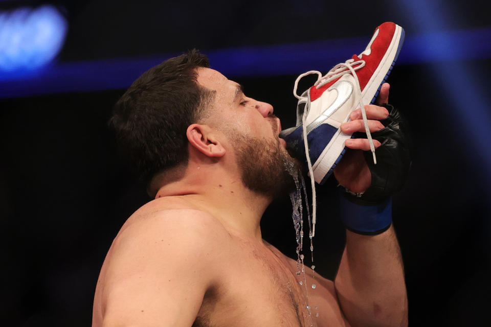 LAS VEGAS, NEVADA - DECEMBER 11: Tai Tuivasa of Australia drinks from his shoe as he celebrates his knockout victory over Augusto Sakai of Brazil in their heavyweight fight during the UFC 269 event at T-Mobile Arena on December 11, 2021 in Las Vegas, Nevada. (Photo by Carmen Mandato/Getty Images)