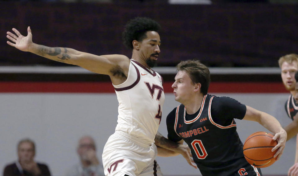 Virginia Tech's Mekhi Long (4) defends Campbell's Gediminas Mokseckas (0) during the first half of an NCAA college basketball game Wednesday, Nov. 15, 2023, in Blacksburg, Va. (Matt Gentry/The Roanoke Times via AP)