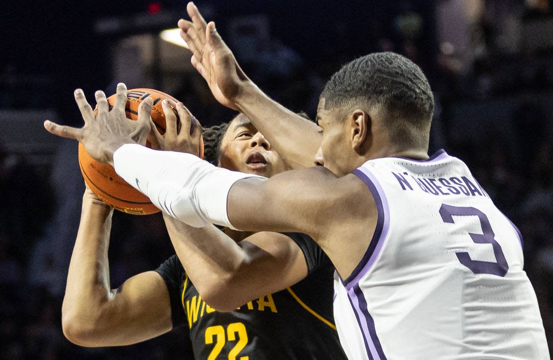 Wichita State’s Shammah Scott gets smothered by Kansas State’s David N’Guessan during the second half on Saturday in Manhattan.
