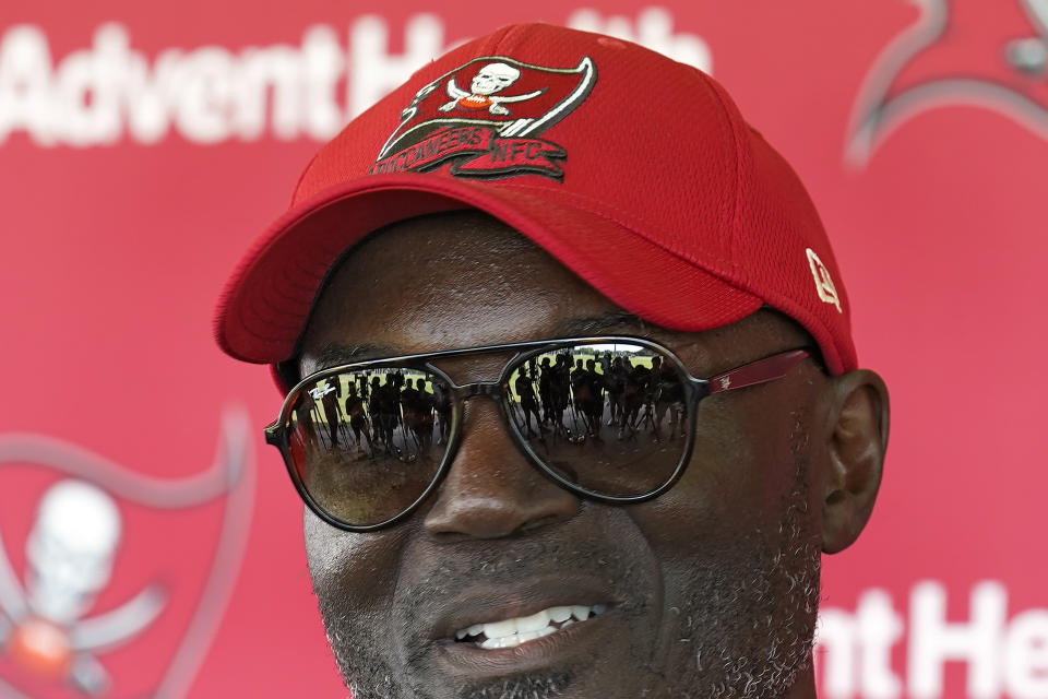 FILE - Members of the media are reflected in Tampa Bay Buccaneers head coach Todd Bowles' sunglasses after NFL football practice Thursday, June 15, 2023, in Tampa, Fla. Bowles also faces the task this summer of retooling a leaky offensive line, rejuvenating one of the NFL's least productive running games and restoring the confidence of a defense that was not as reliable as usual last season. (AP Photo/Chris O'Meara, File)