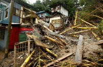 <p>Houses damaged by a mudslide are seen during heavy rains of Tropical Storm Nate that affects the country in San Jose, Costa Rica, Oct. 5, 2017. (Photo: Juan Carlos Ulate/Reuters) </p>