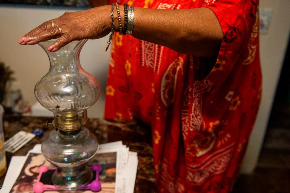 Mary Gipson displays a vintage lantern at the family home on School Street in Ocean Springs on Tuesday, Sept. 26, 2023. Gipson’s father built the house and owned other property in the area.