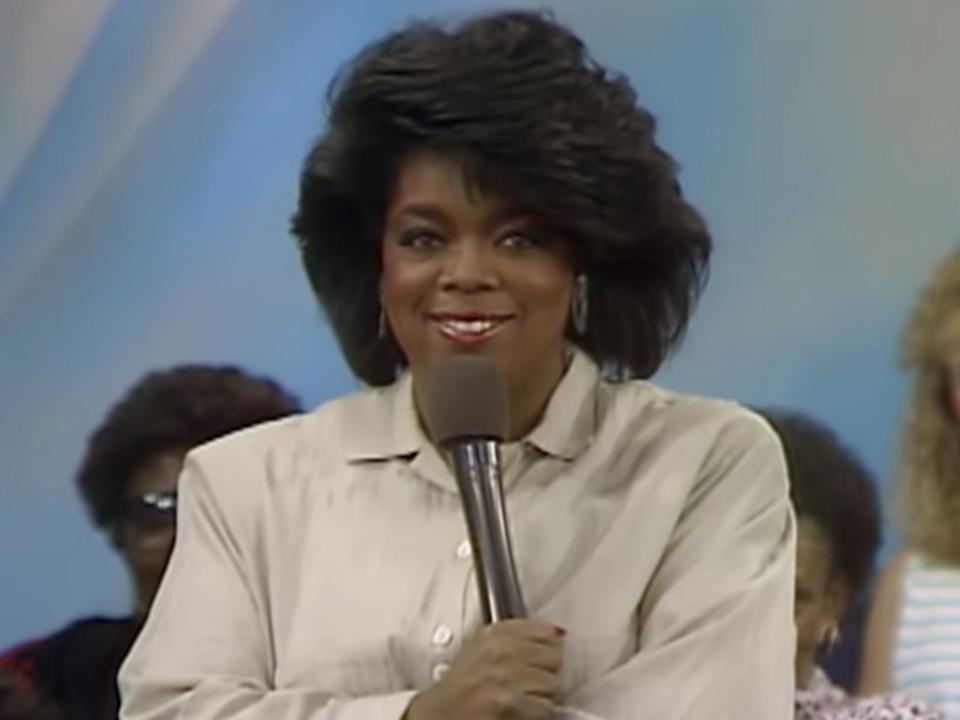 Oprah Winfrey holding a microphone in an episode of her TV show
