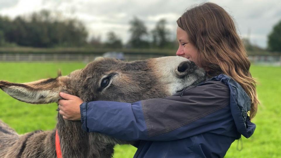 Janneke Merkx with one of the donkeys at the Donkey Sanctuary