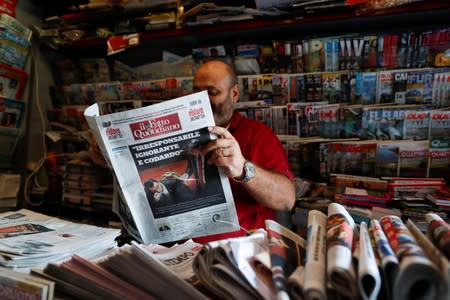 A kiosk oner reads a newspaper with news of Government crisis and the resignation of the prime minister Giuseppe Conte