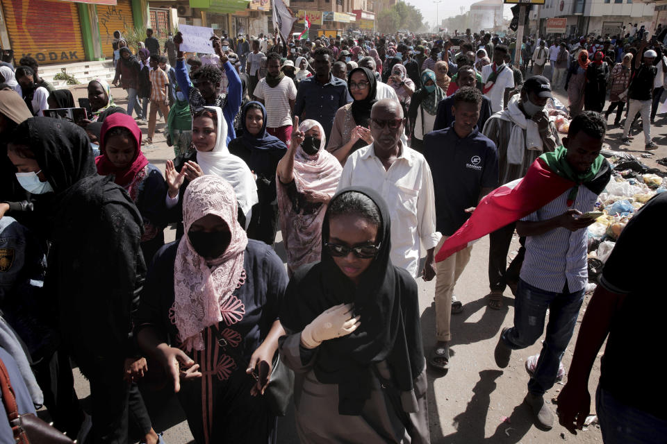 People march in a demonstration against the killing of dozens by Sudanese security forces since a military coup three months ago, in Khartoum, Sudan, Monday, Jan. 24, 2022. (AP Photo/Marwan Ali)