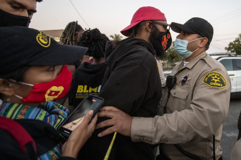 Residents confront L.A. County sheriff's deputies after officers fatally shot a Black man in South L.A.