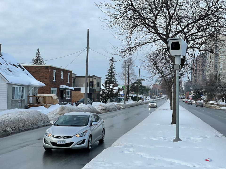 A car drives past a photo radar camera in a residential neighbourhood of Ottawa Dec. 30, 2022.
