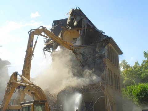 caterpillar building demolition implosion crushed collapsed