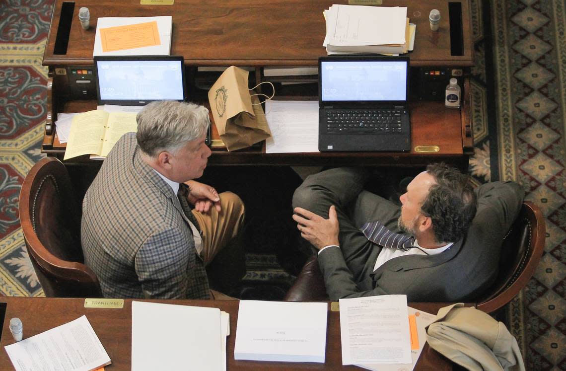 Rep. Mark Willis, left, talks with Rep. Bruce Bannister during a House of Representatives session in Columbia, S.C. on Tuesday, March 29, 2022. (Travis Bell/STATEHOUSE CAROLINA)