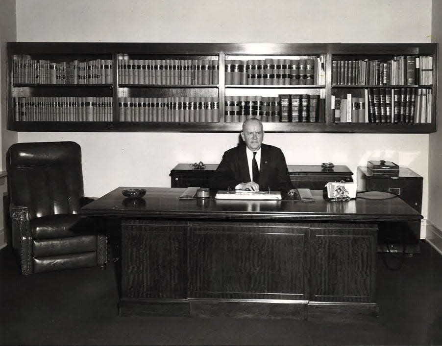 Warner Pomerene of the law firm now known as Pomerene, Burns and Skelton sitting at a desk with a credenza still being used by current partner Bob Skelton.