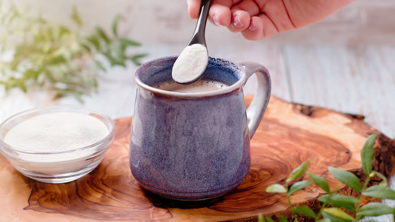 adding powder to drink