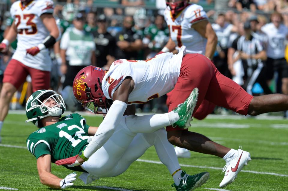 Ohio Bobcats wide receiver Sam Wiglusz (12) takes a hit from Iowa State Cyclones defensive back T.J. Tampa (2) during the second quarter at Peden Stadium.