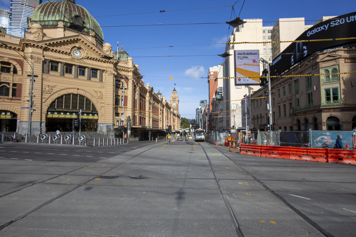 MELBOURNE, AUSTRALIA - MARCH 30: A deserted Flinders Street train station on March 30, 2020 in Melbourne, Australia. Public gatherings are now limited to two people, as the Australian Government introduces tougher restrictions in response to the COVID-19 pandemic. Prime Minister Scott Morrison on Sunday told Australians to stay home unless they are shopping for food, receiving medical attention, going to work or education, or for exercise, which is now limited to groups of two. People over 70 have been told to remain inside while public areas such as playgrounds, outside gyms and skateparks will be closed from midday on Monday. International arrivals into Australia are being quarantined in hotels on arrival. (Photo by Bill Blair#JM/Getty Images)