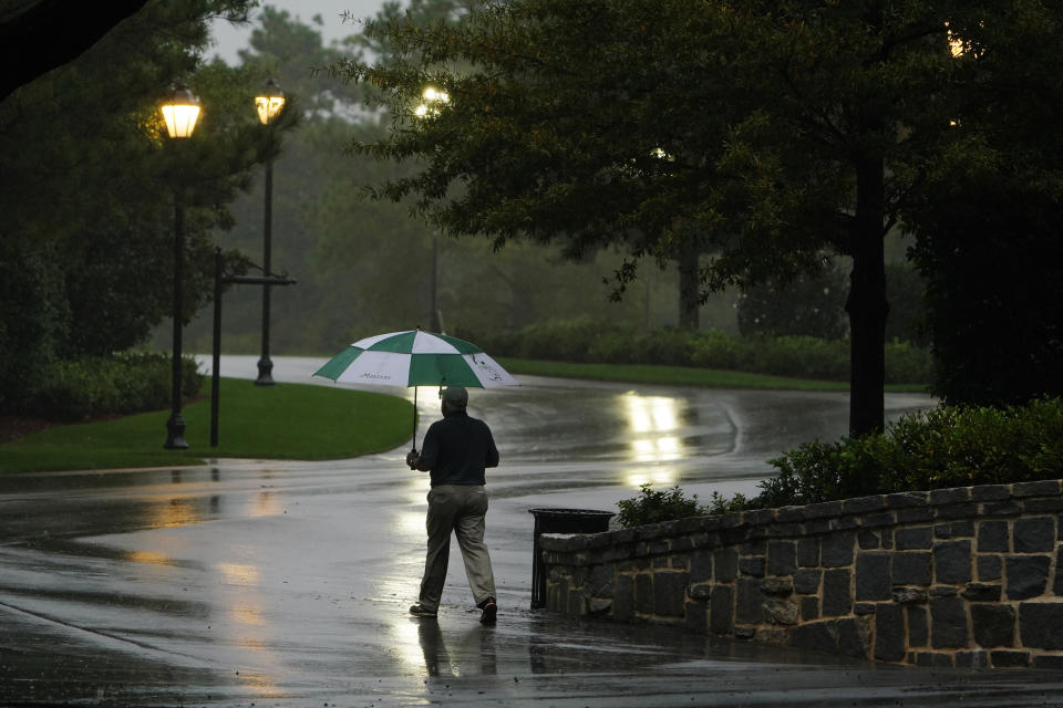 A patron walks out of the Augusta National Golf Course after play was suspended during the first round of the Masters golf tournament Thursday, Nov. 12, 2020, in Augusta, Ga. (AP Photo/Matt Slocum)