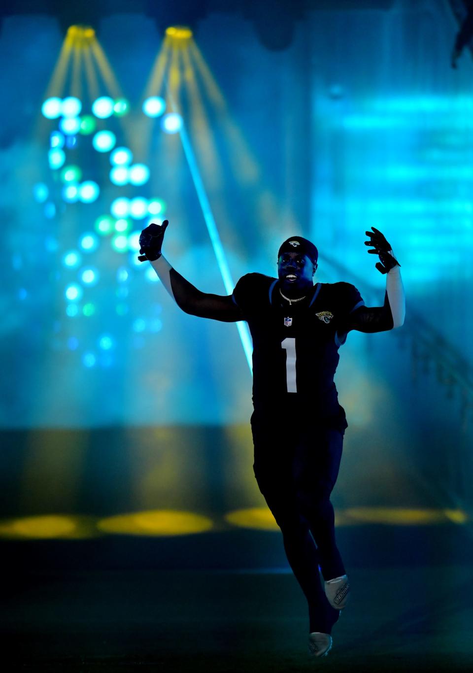 Jacksonville Jaguars running back Travis Etienne Jr. (1) runs out of the tunnel to the field through smoke, light's and lasers before the start of Monday night's game against the Bengals. The Jacksonville Jaguars hosted the Cincinnati Bengals at EverBank Stadium in Jacksonville, Florida for Monday Night Football, December 4, 2023. The Jaguars were tied 14 to 14 at the end of the first half. [Bob Self/Florida Times-Union]