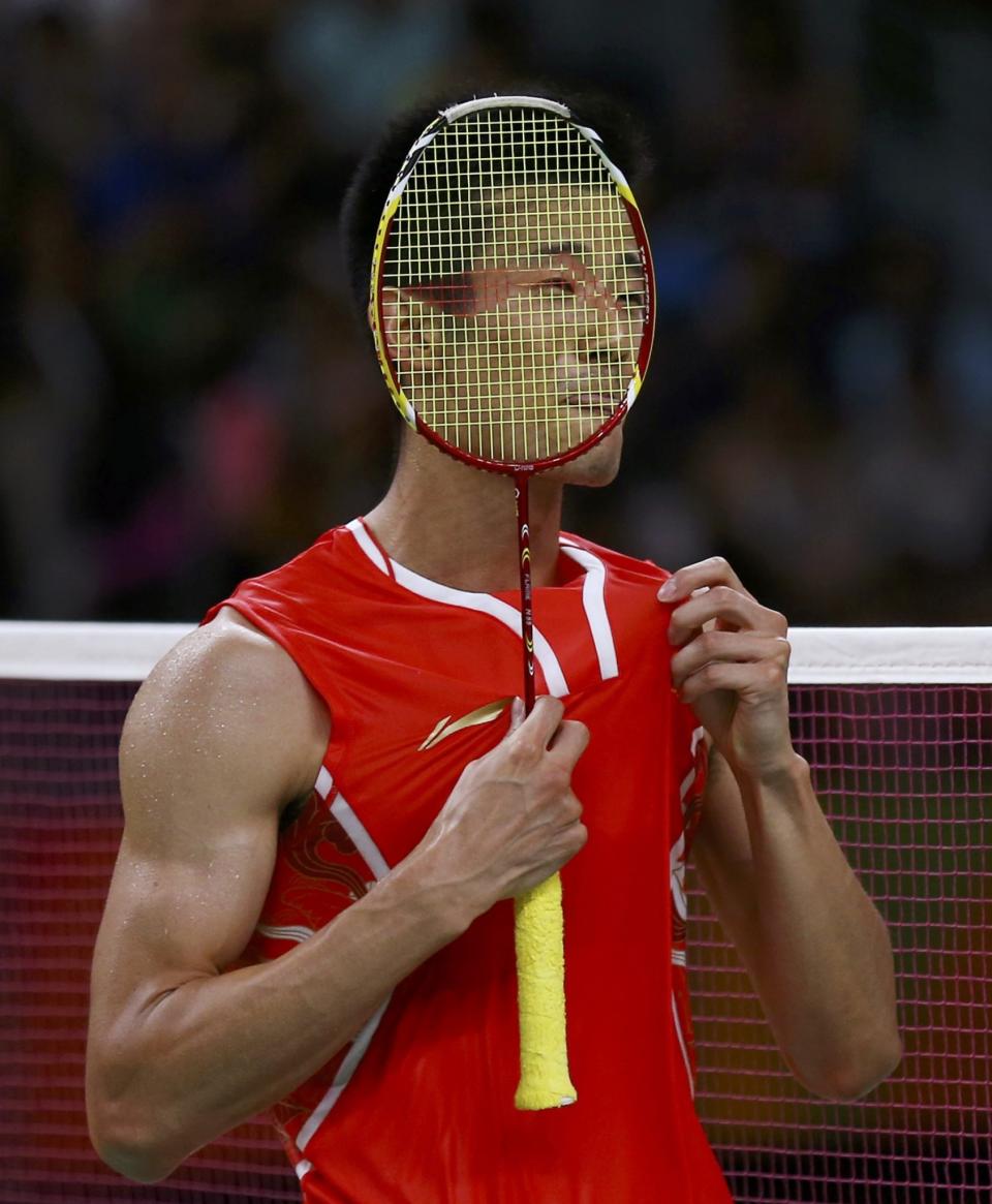 <p>Chen Long (CHN) of China is seen through his racquet after winning his match. (Reuters) </p>