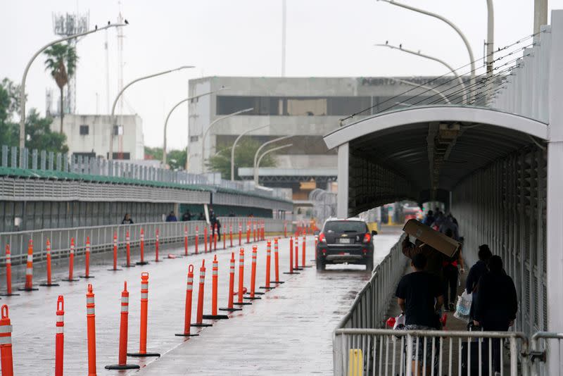 People cross towards Mexico as efforts to try to slow the spread of the coronavirus disease continues in Laredo