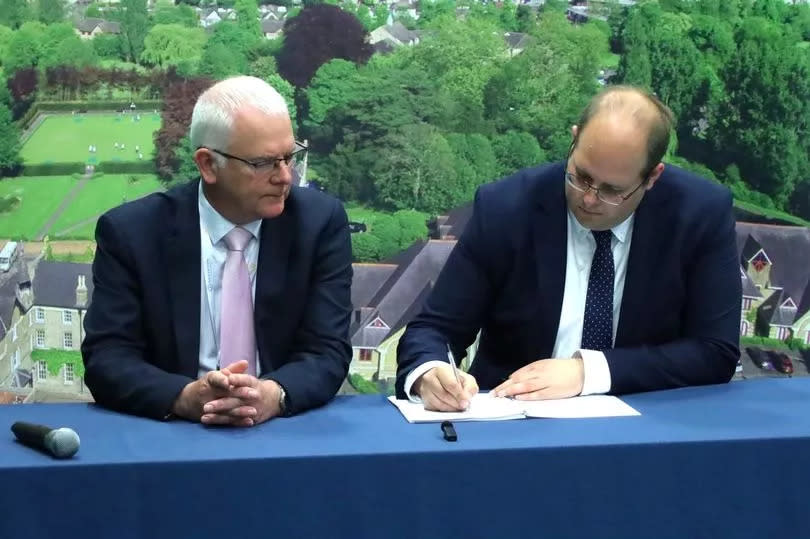 Jonathan Ash-Edwards (right) signs a declaration as he becomes Hertfordshire's second-ever police and crime commissioner, overseen by returning officer Jeff Stack (left)