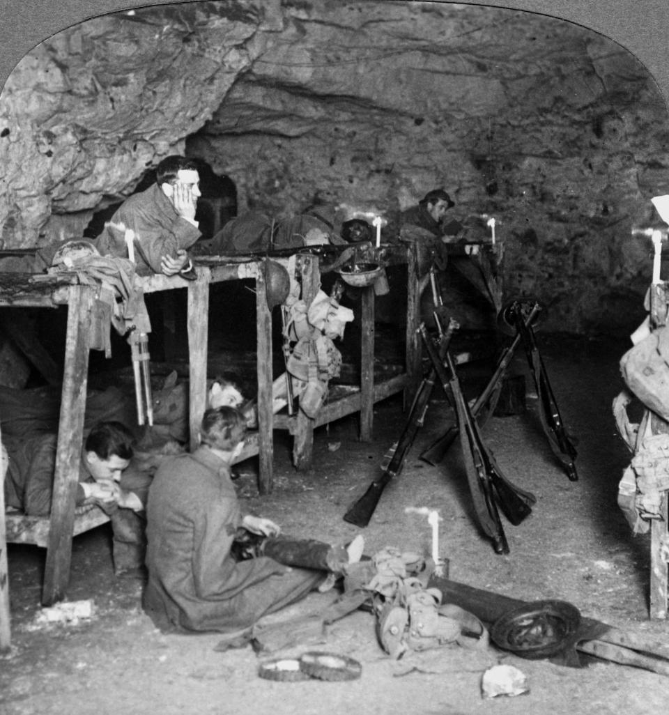 A black and white photo of men in an underground bunker.
