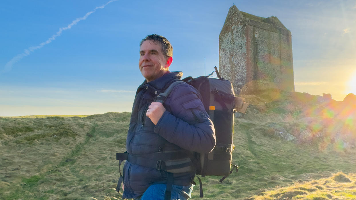  Lowepro Pro Trekker BP 650 AW II backpack on a man's back outside in the scottish highlands. 