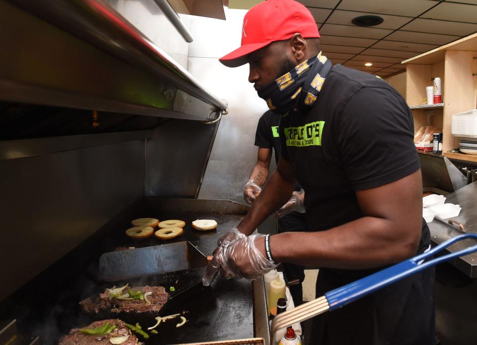 The Philly bagel is one of the popular items at Triple D's Tasty Grill in The Liberty Plaza. Owner Darrell Roberts is shown on May 14 making sandwiches for takeout. Roberts received a $16,500 loan in July, from the  Erie County Redevelopment Authority's micro-loan program, to help with the operating costs of his new business.