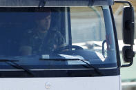 A soldier drives a jet fuel tanker truck at a fuel depot in Aveiras, outside Lisbon, Tuesday, Aug. 13, 2019. Soldiers are driving tanker trucks to distribute gas in Portugal as an open-ended truckers' strike over pay enters its second day. The government has issued an order allowing the army to be used. (AP Photo/Armando Franca)